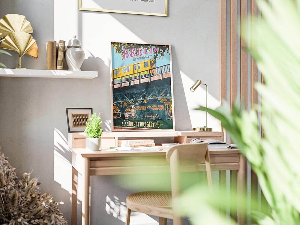 Berlin Burgermeister vintage poster leaning on a wooden desk in a bright modern home office with natural sunligh