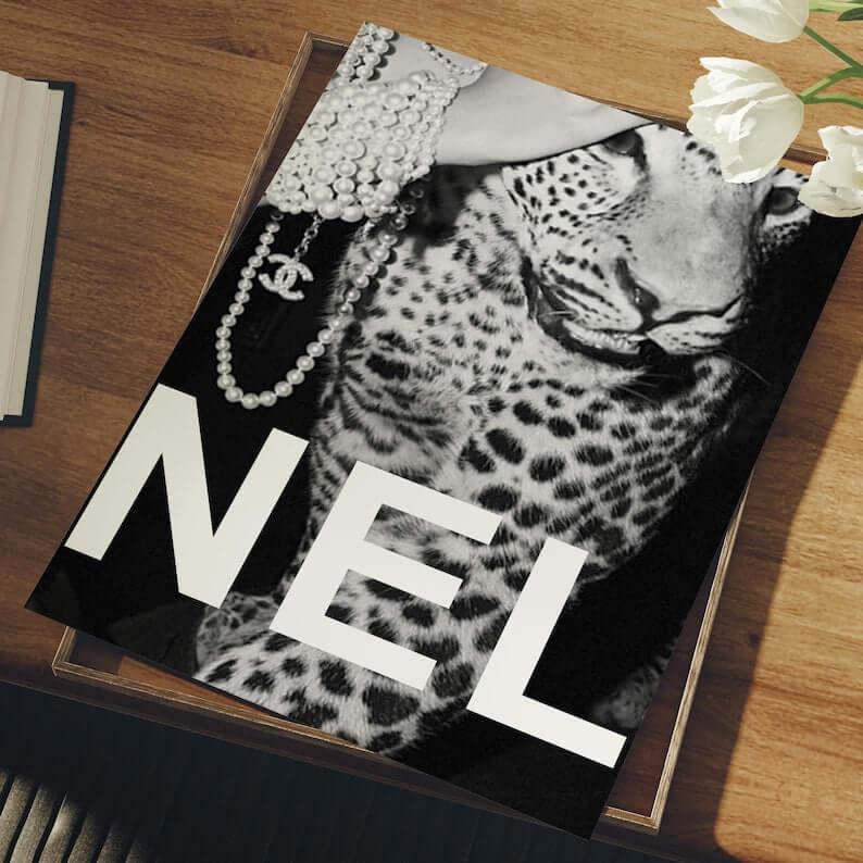 Right print close up of a pearl draped leopard with bold NEL lettering