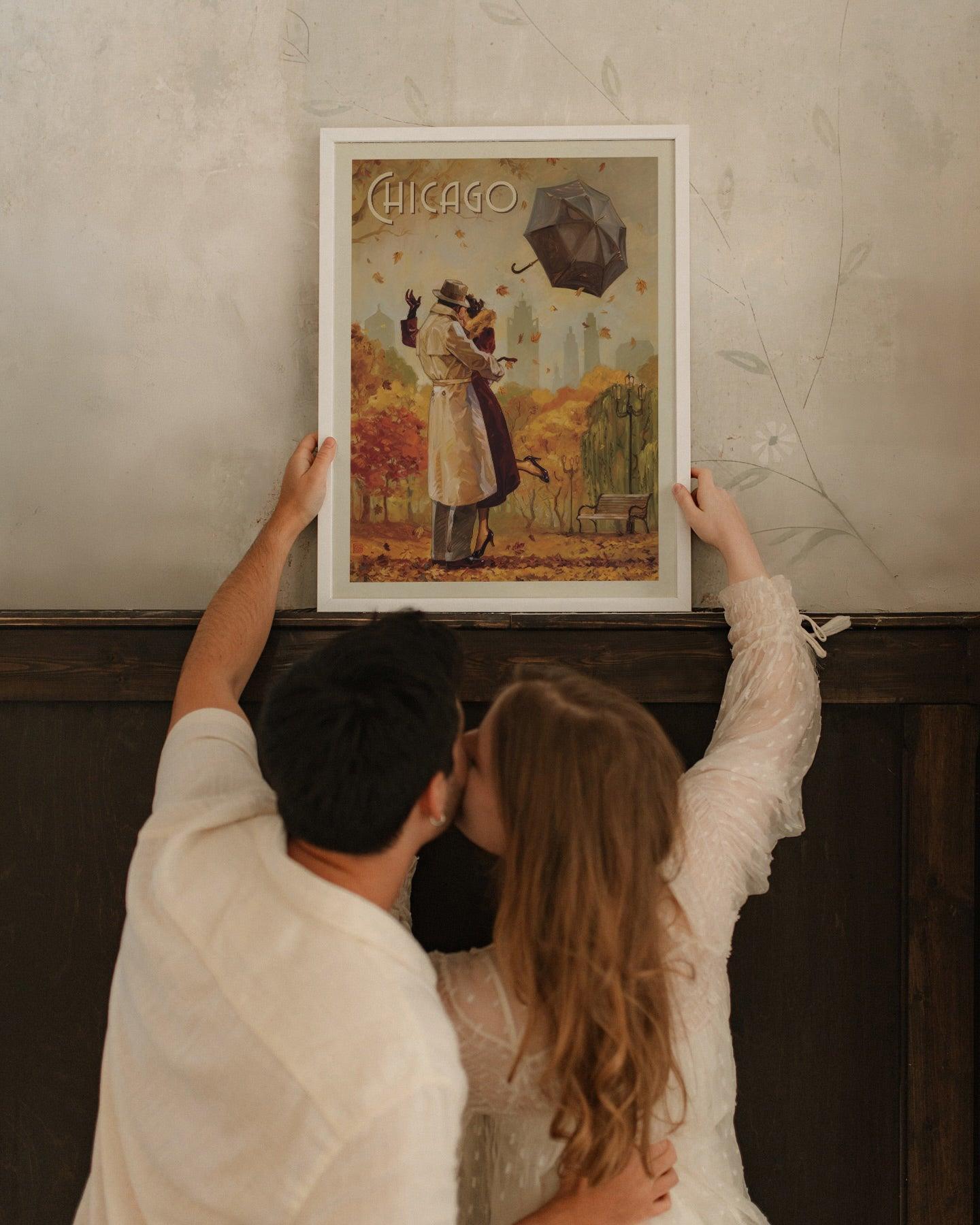 Couple kissing while hanging the white framed Chicago poster, autumn romance wall art detail