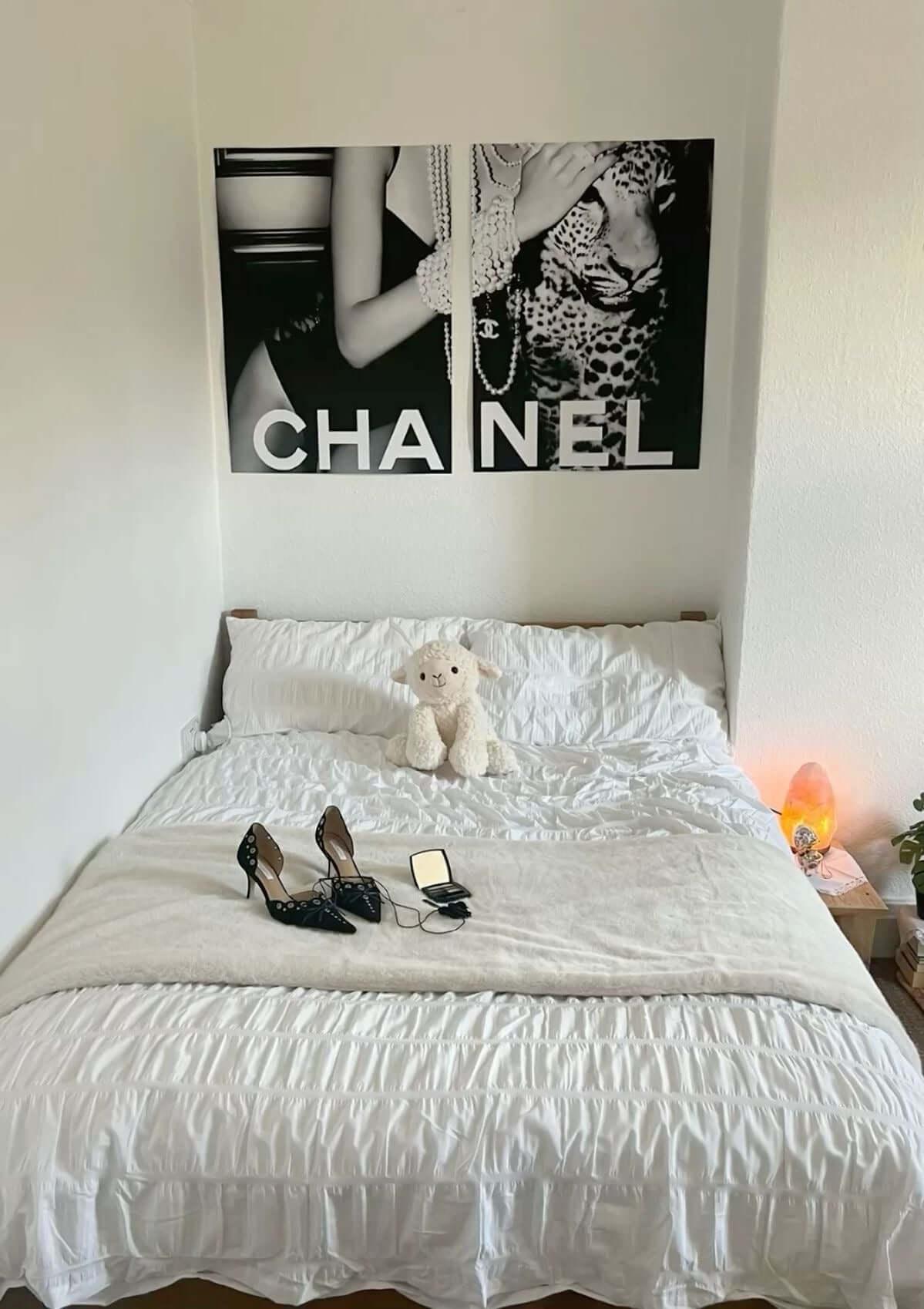 Set of 2 black and white fashion posters featuring leopard print Chanel style in a bedroom decor