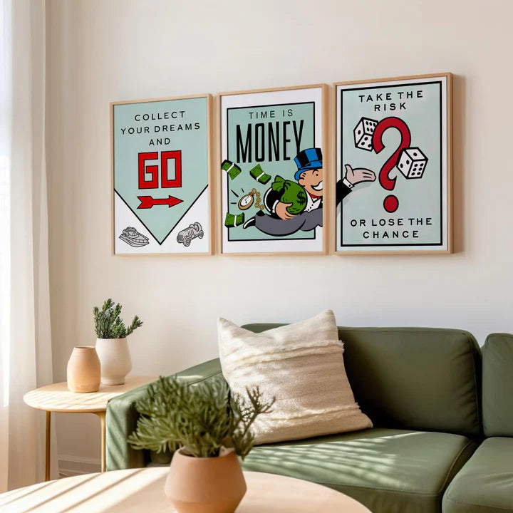 Set of 3 Monopoly style motivational posters in natural wood frames above a green sofa in a bright room