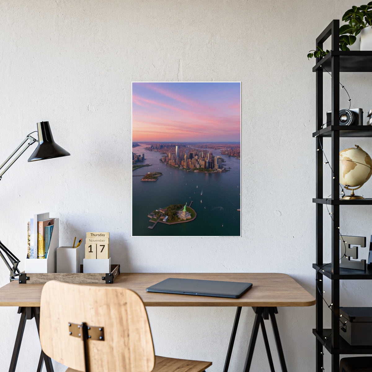 NYC skyline sunset wall art above a home office desk with lamp and globe shelf